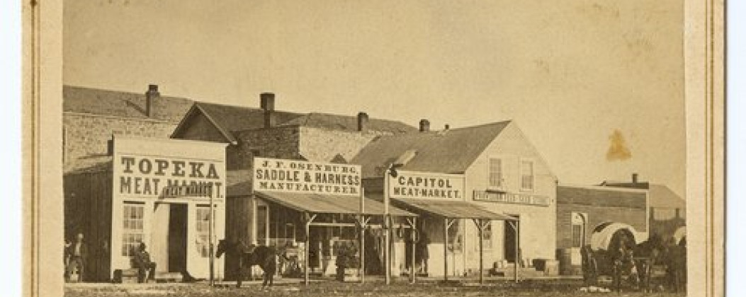 Kansas Avenue, Topeka, Kansas, Between 1863 and 1865, A carte-de-visite showing the east side of Kansas Avenue near the corner of 6th Street in Topeka, Kansas, Courtesy of Kansas State Historical Society, https://www.kansasmemory.gov/item/216939