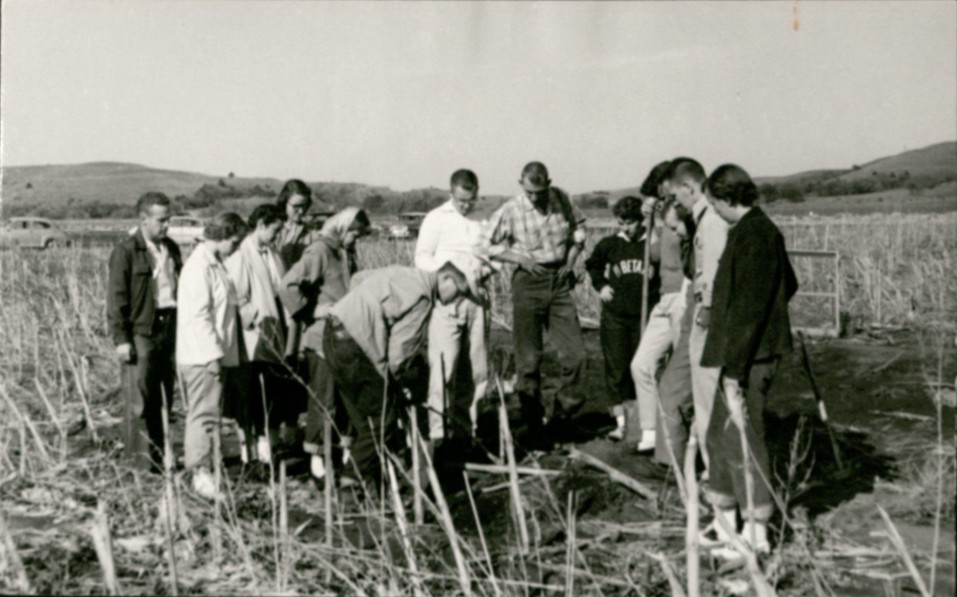 KSU Archaeology Field Trip c. 1950s. Dr. Linwood Hodgdon (center) with shovel. (Image courtesy of Morse Department of Special Collections, Kansas State University Libraries)